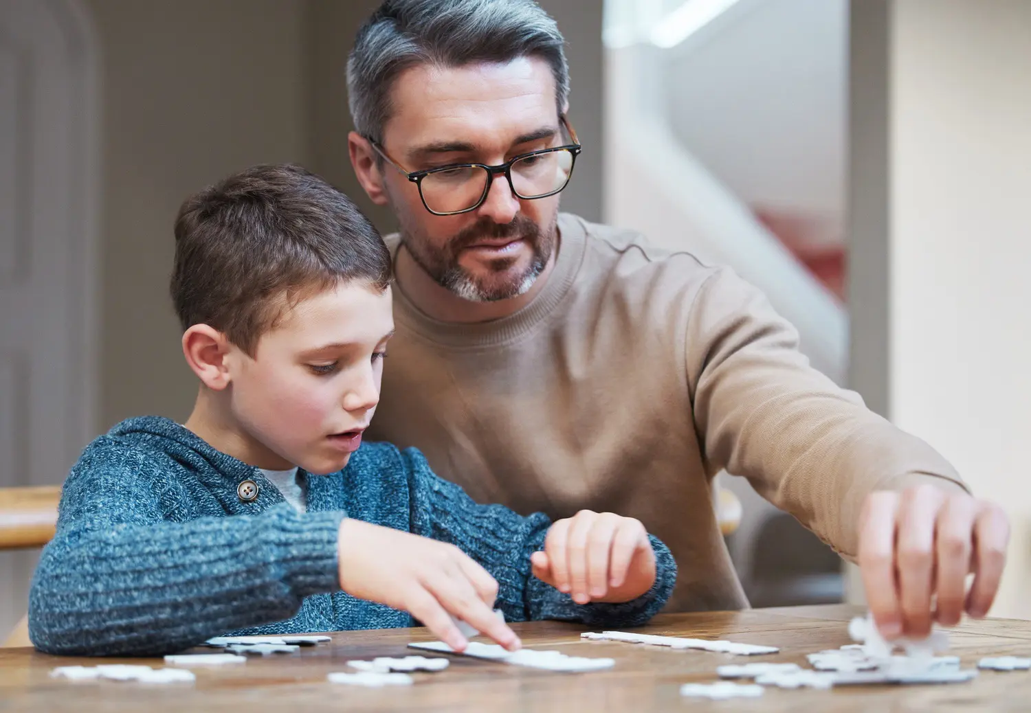 father and son playing a jigsaw puzzle together utc