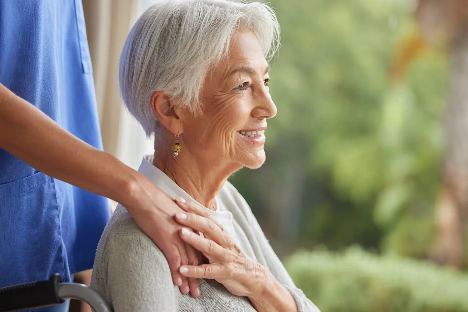 smiling senior woman receives care from nurse utc